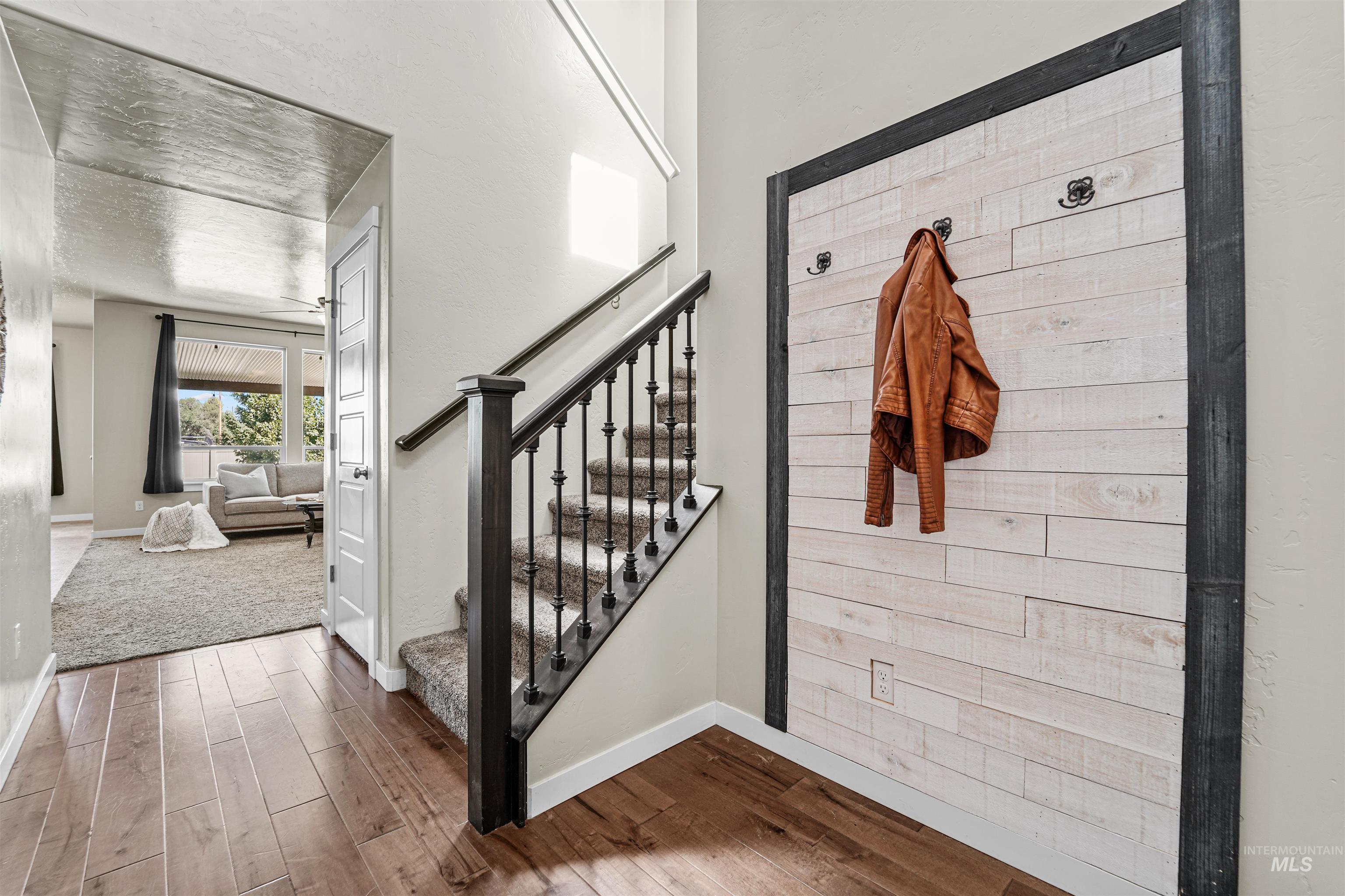 Stairway featuring wood finished floors and baseboards