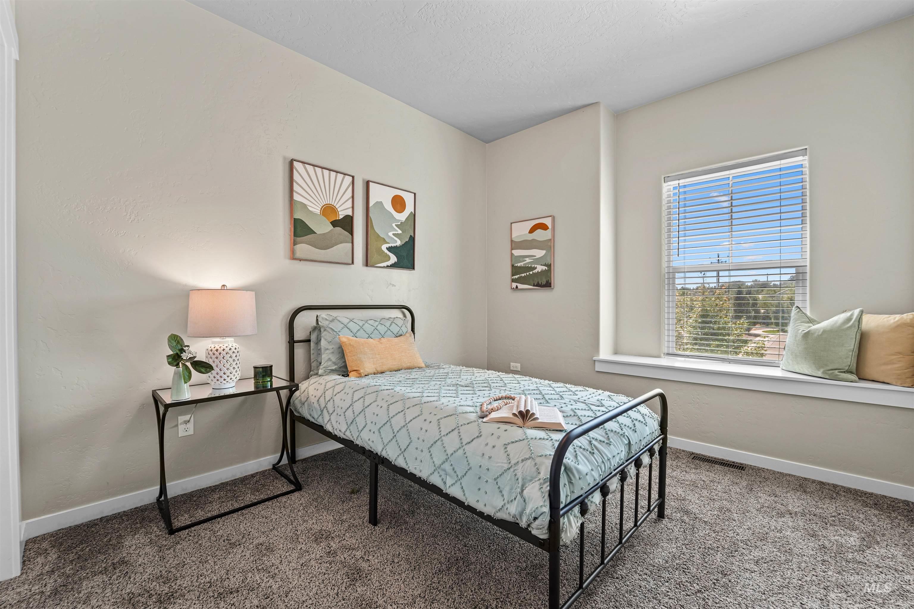 Bedroom with carpet floors and baseboards
