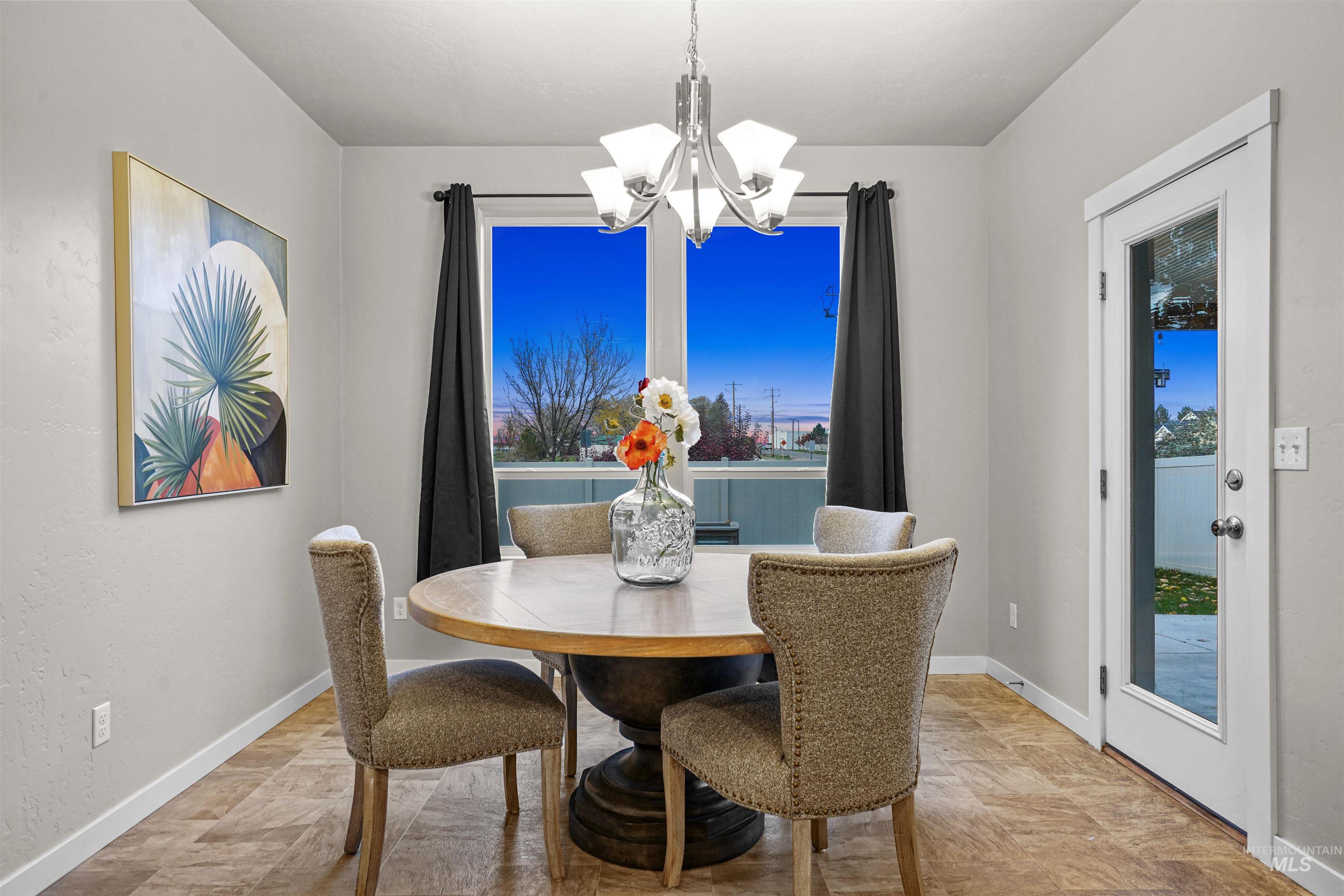 Dining space with a chandelier and baseboards