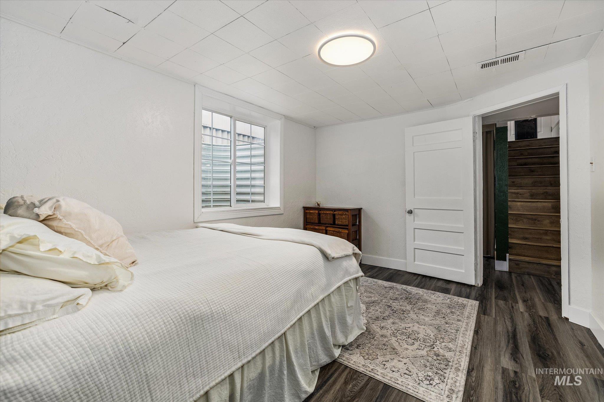 Bedroom featuring dark wood-style floors