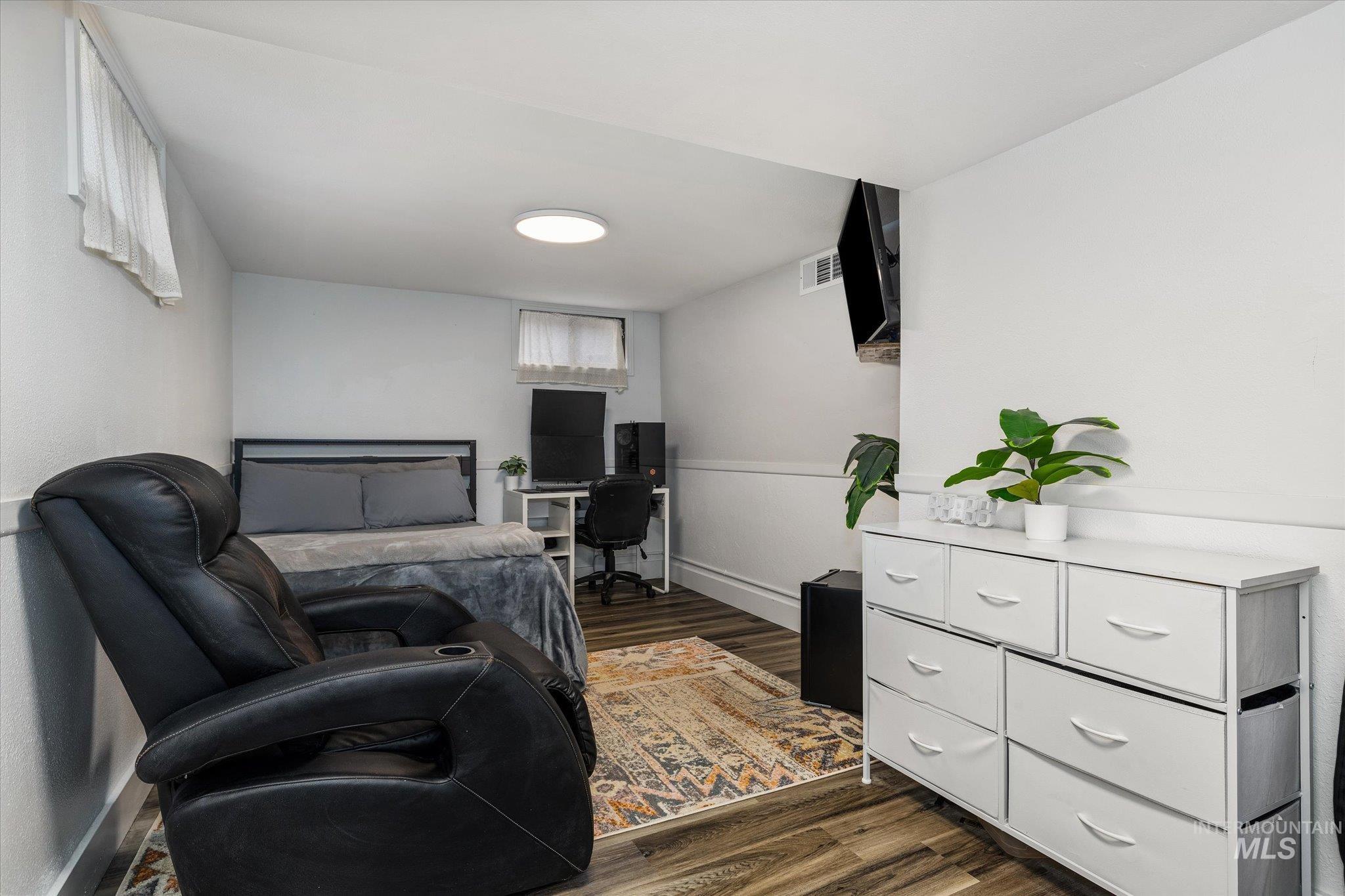 Sitting room featuring a desk and dark wood-style floors