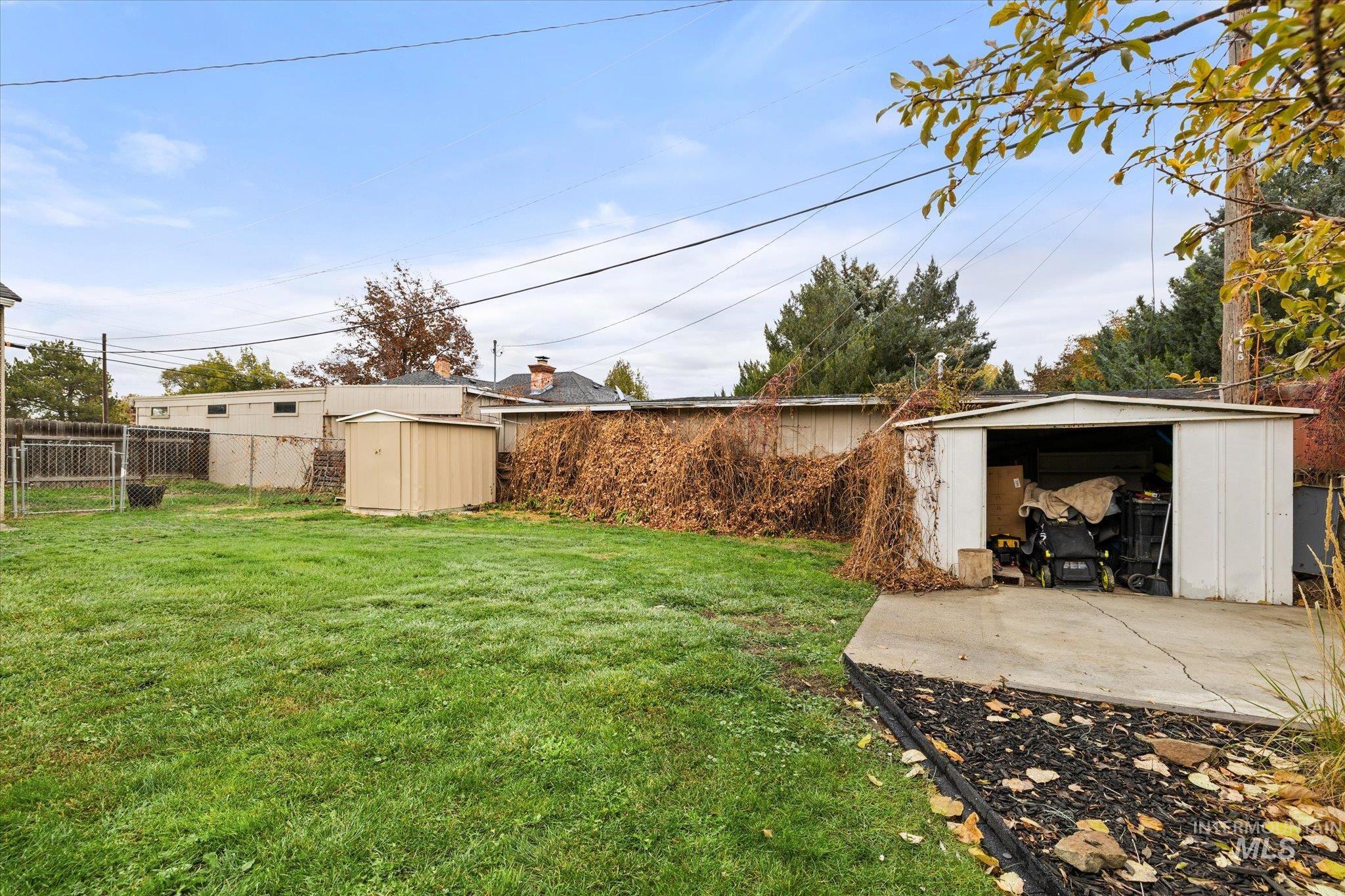 View of yard with a shed and a patio area
