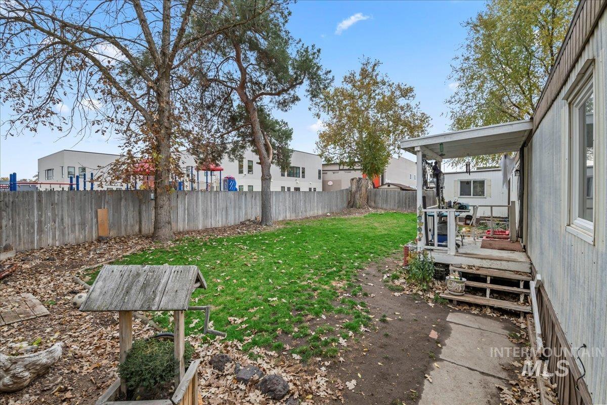 Fenced backyard with a wooden deck