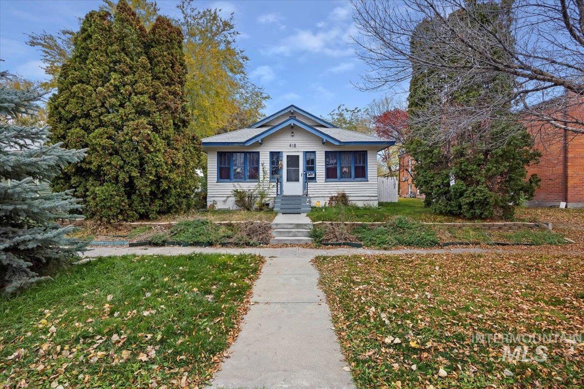 Bungalow-style home with a front yard