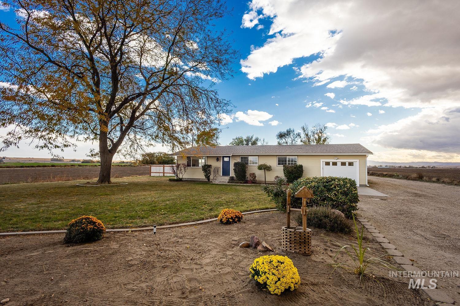 Ranch-style house with a front yard and a garage