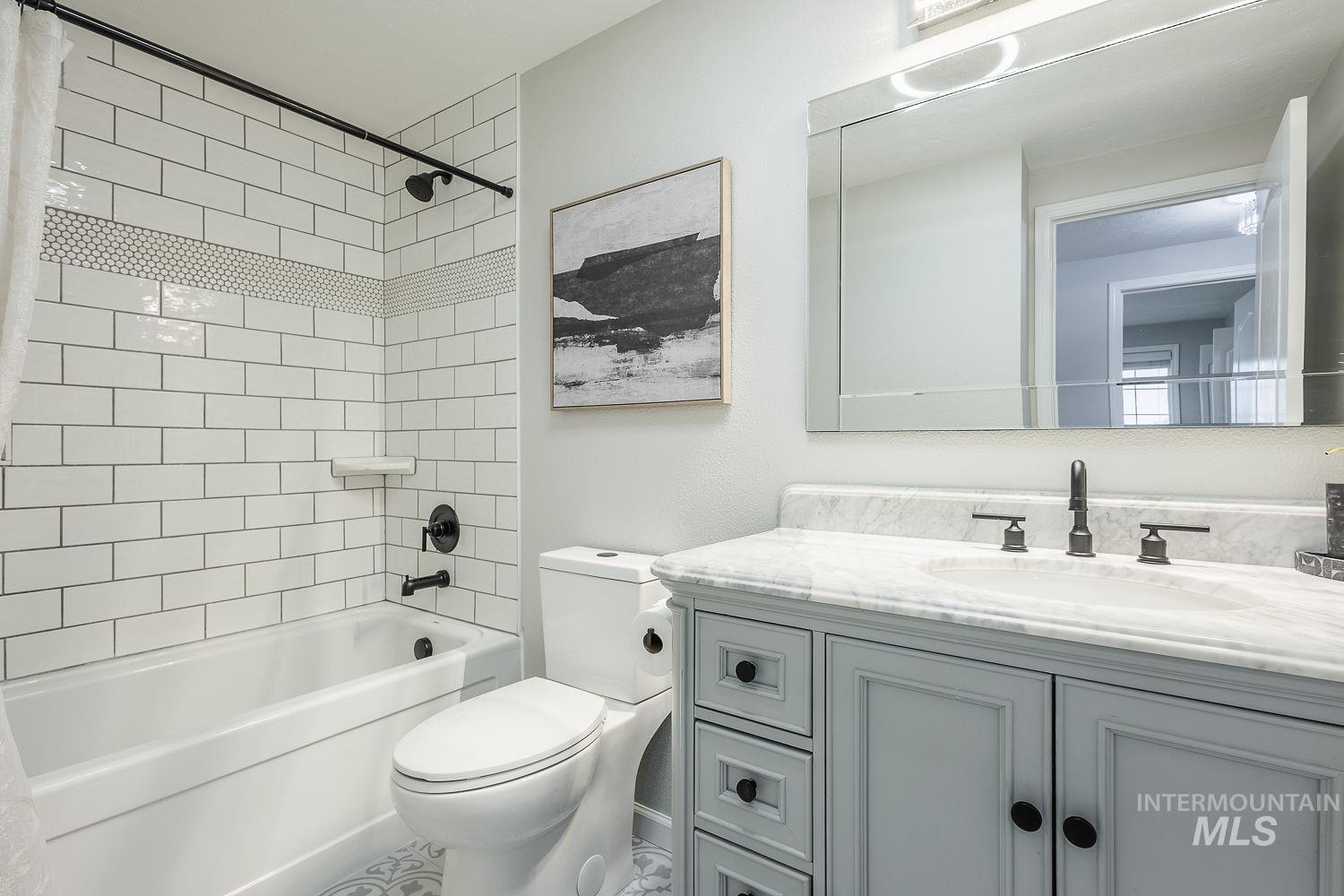 Bathroom with shower / bathtub combination and vanity