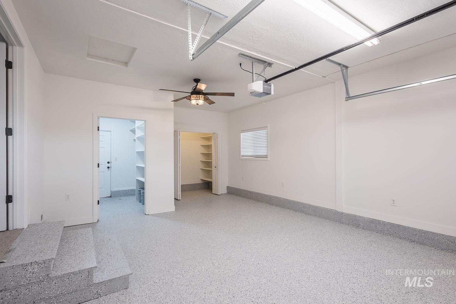 Garage featuring a ceiling fan and a garage door opener
