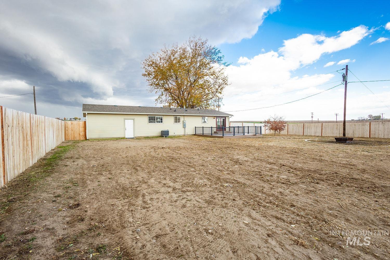 Rear view of property featuring a fenced backyard