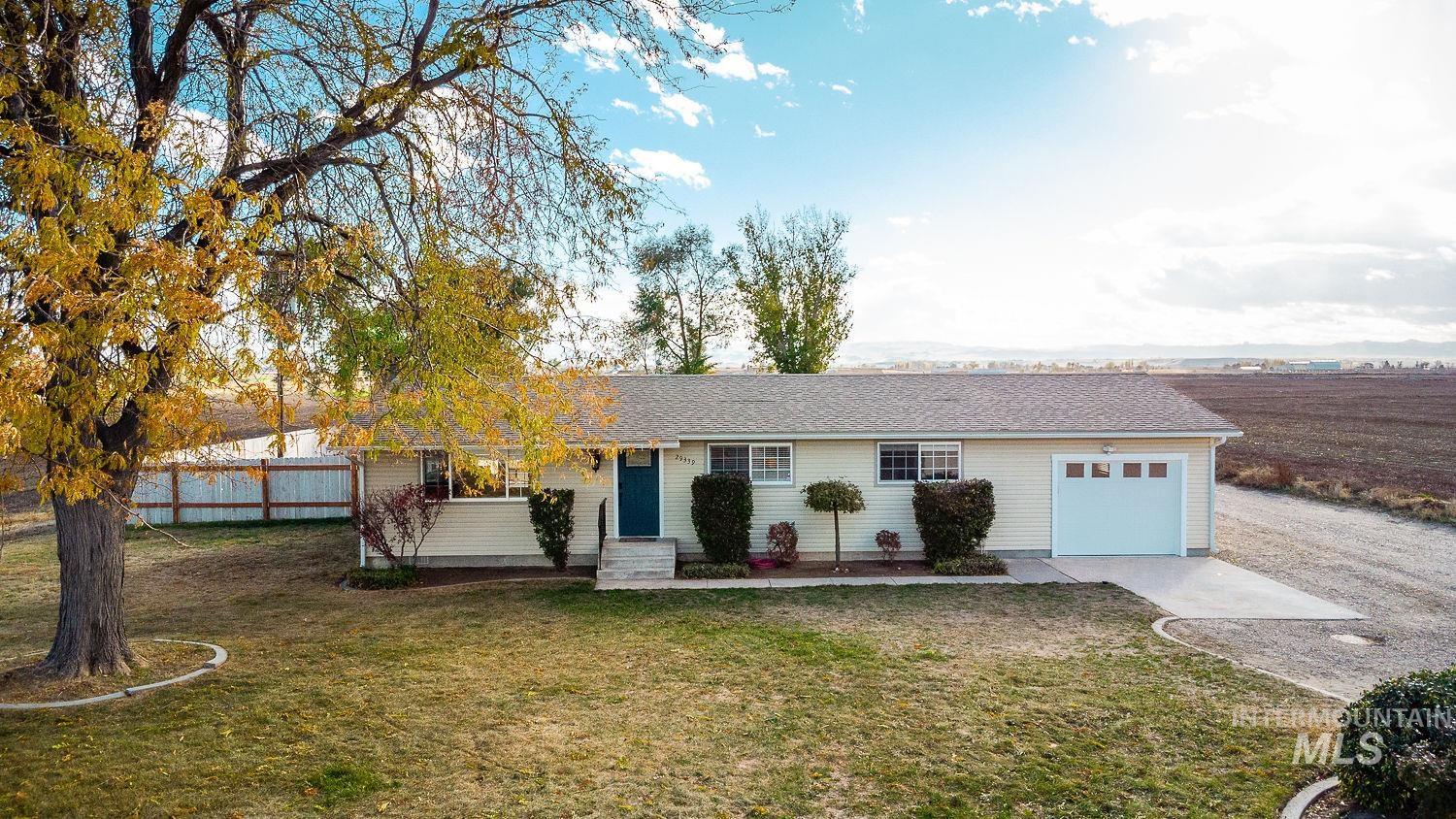 Ranch-style house with a shingled roof and a garage