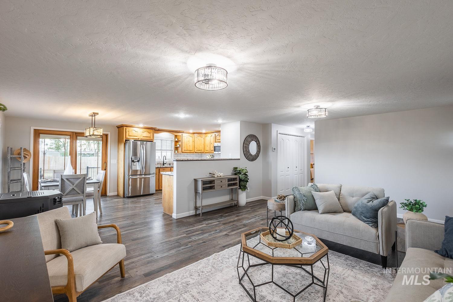 Living room with dark wood-style floors and a textured ceiling