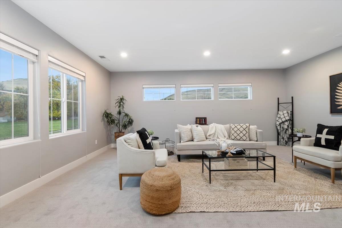 Bonus room with carpet floors and recessed lighting