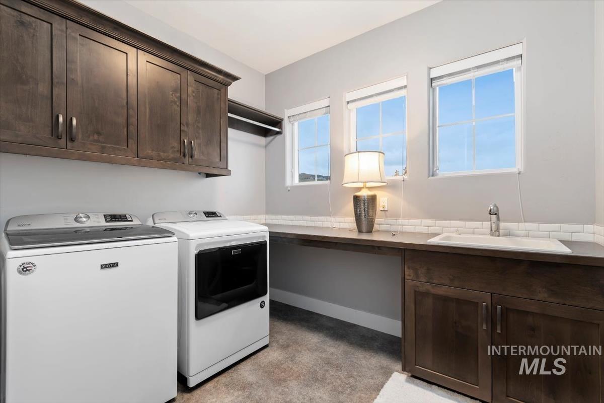 Laundry room with cabinet space and washer and clothes dryer