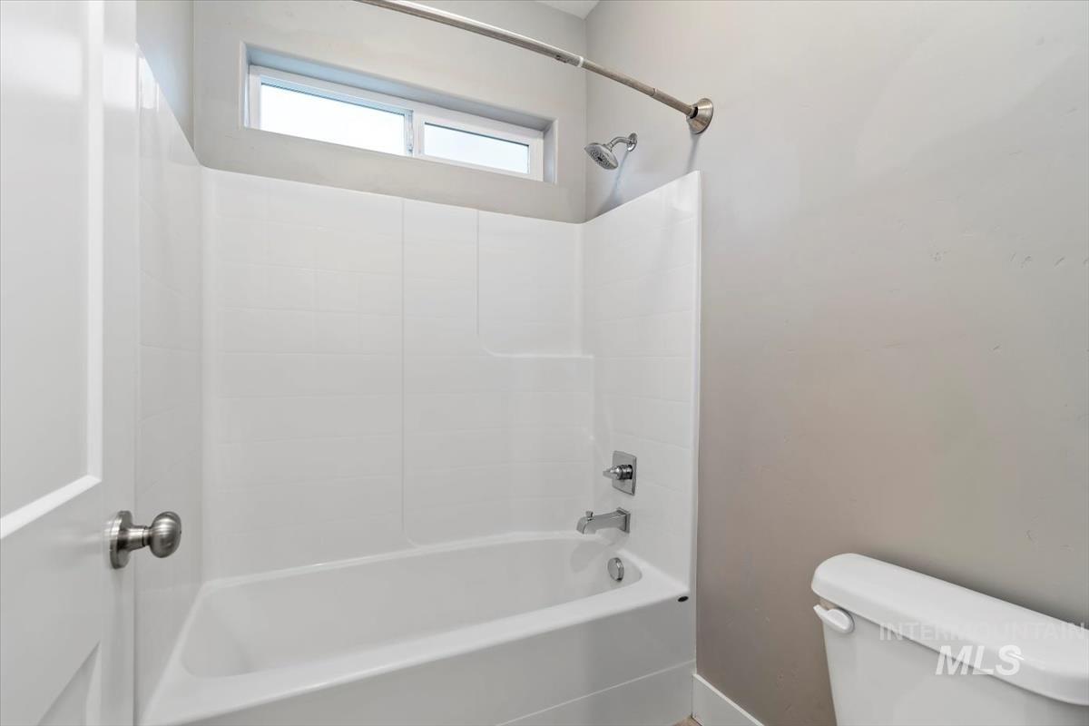 Full bath with bathing tub / shower combination and toilet