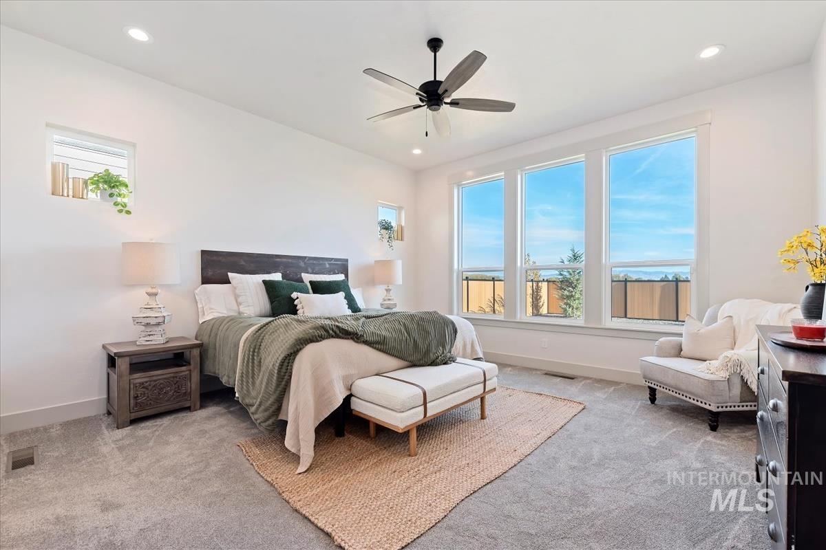 Bedroom featuring light colored carpet, recessed lighting, and ceiling fan