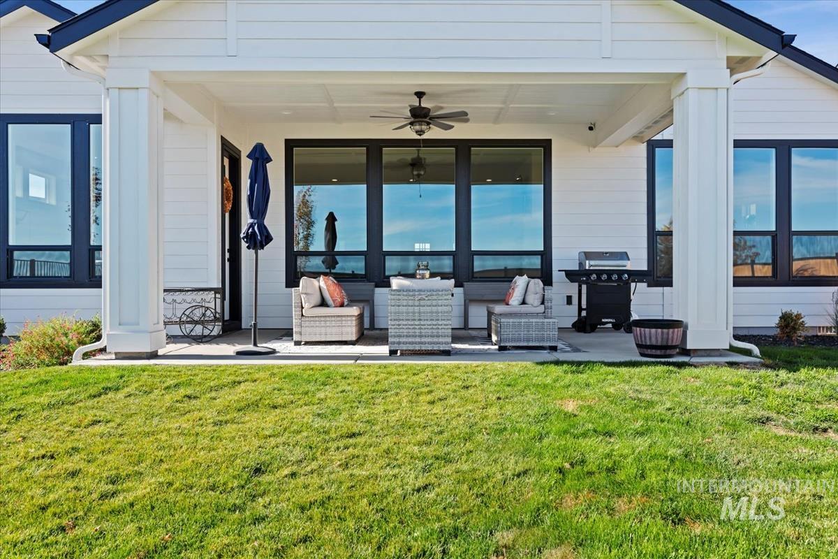 View of patio with a ceiling fan, area for grilling, and outdoor lounge area