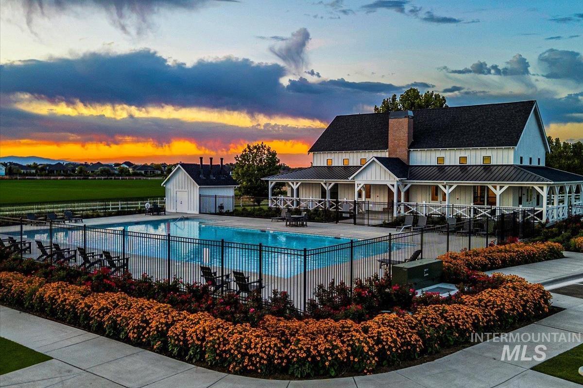 Pool at dusk with a community pool and a patio area
