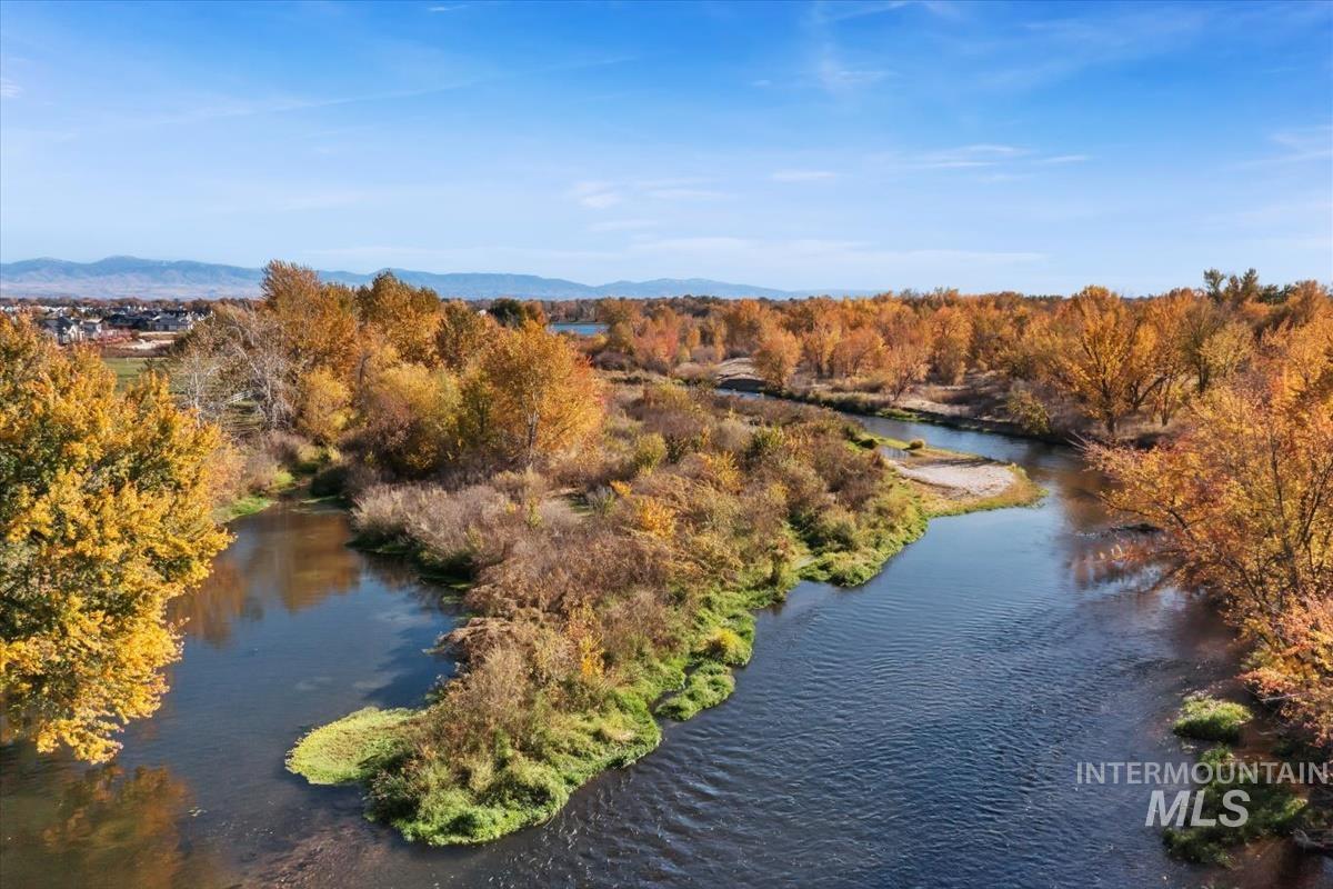 Aerial view of property and surrounding area featuring a large body of water
