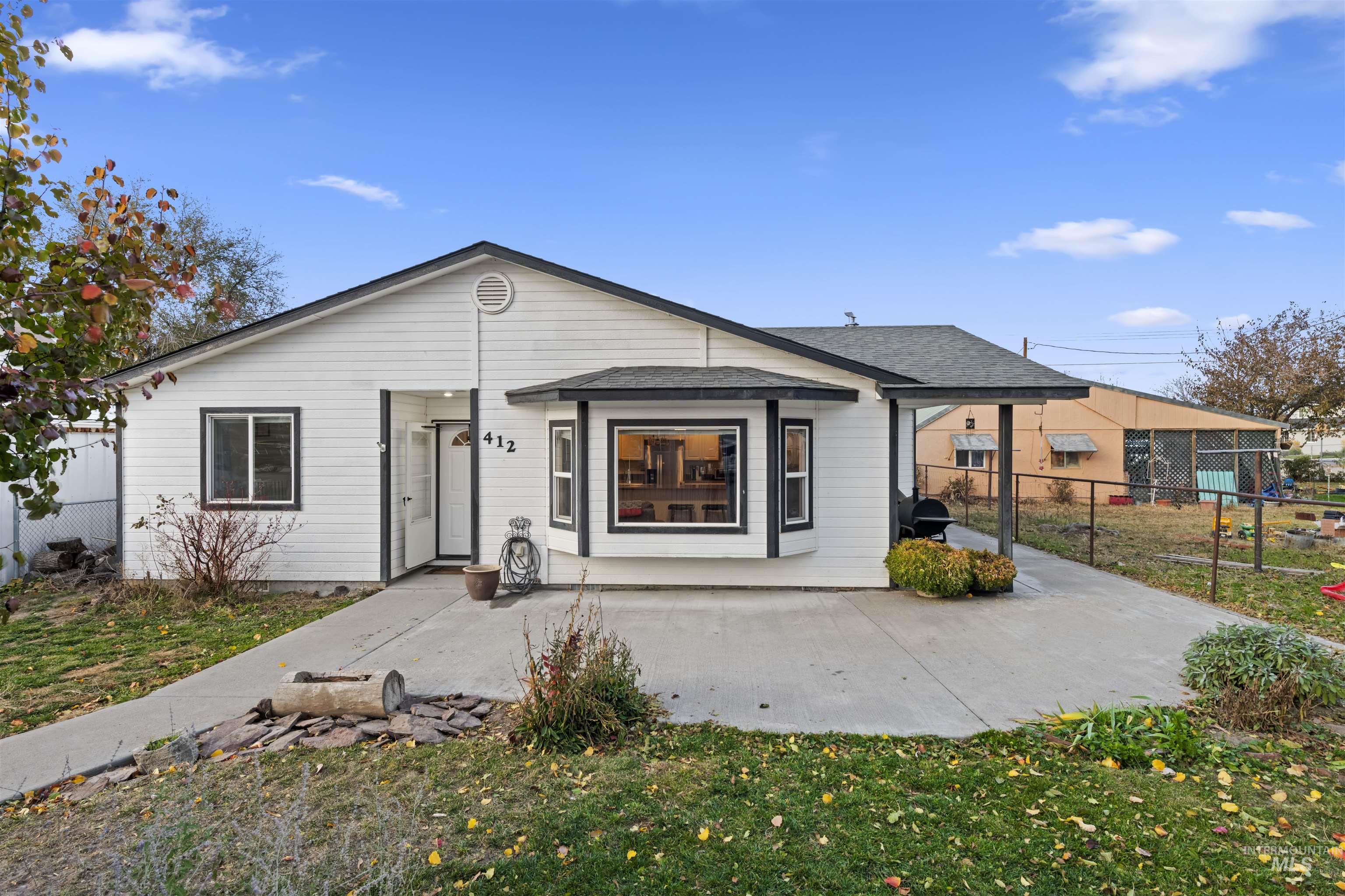 Back of house featuring a patio and a shingled roof