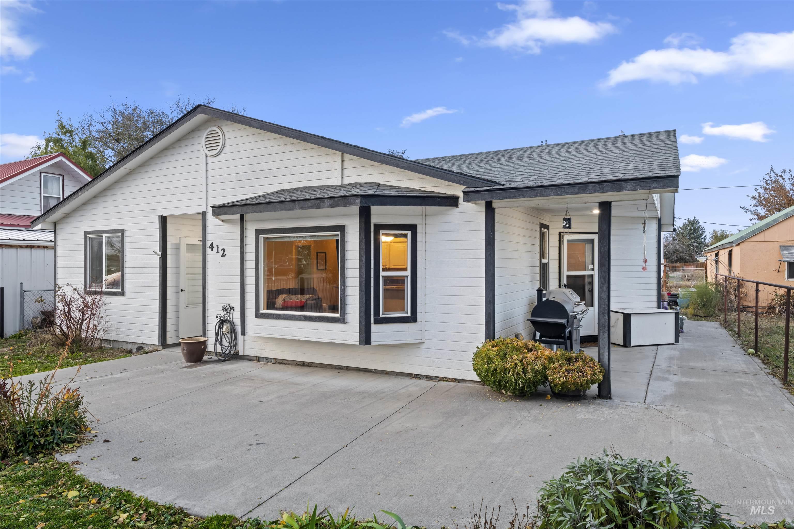 View of front of home featuring a shingled roof and a porch