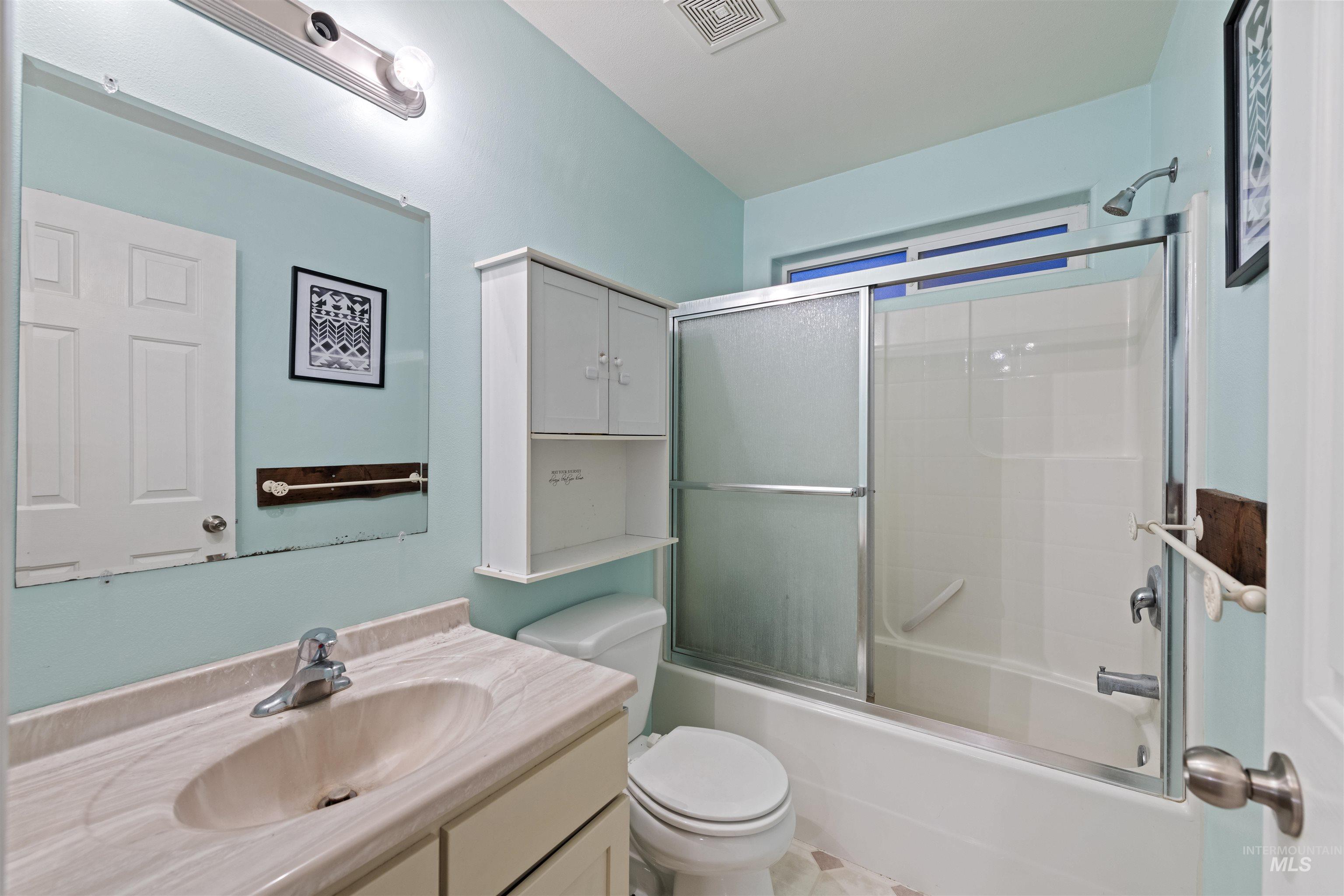 Full bathroom with vanity and shower / bath combination with glass door
