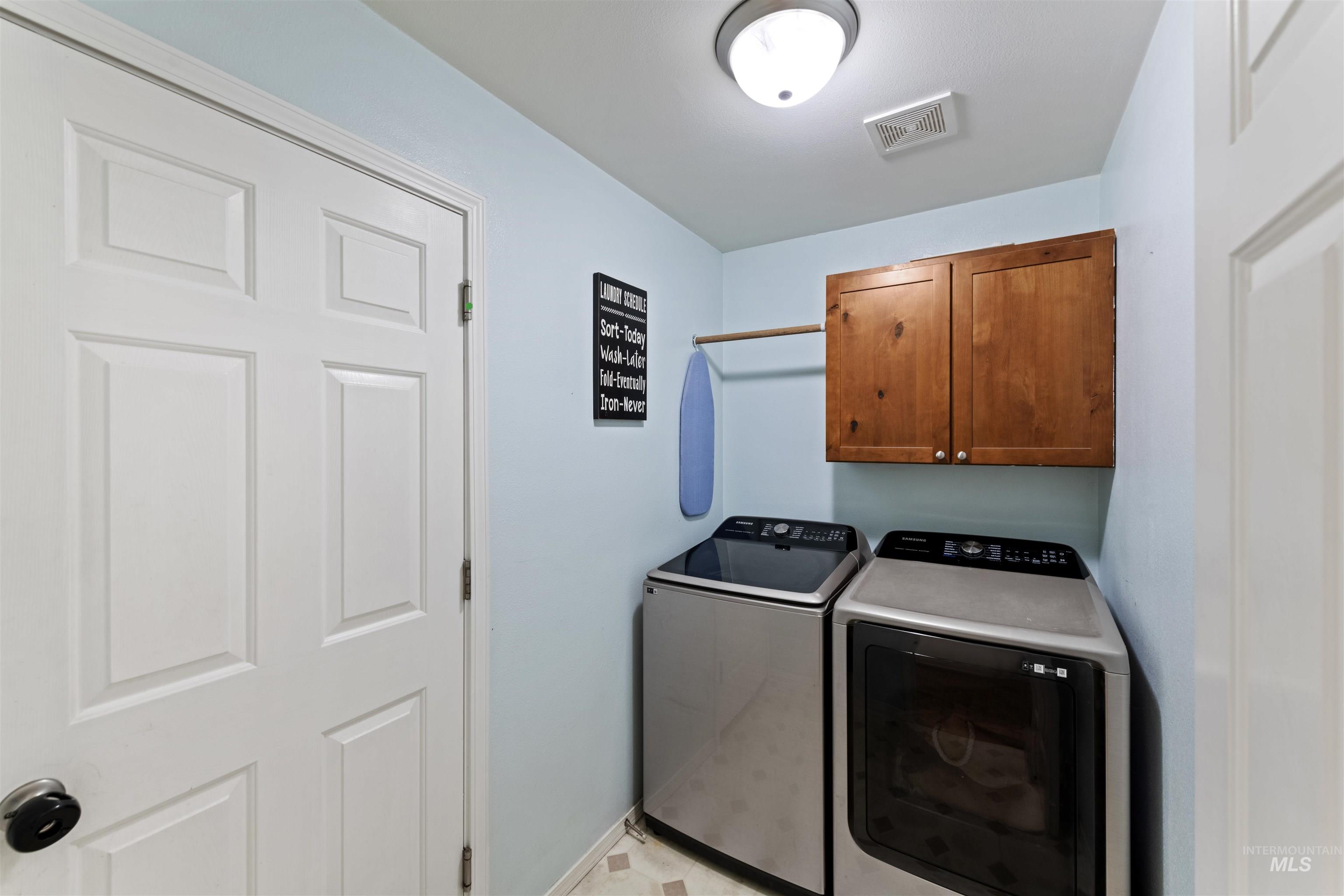 Washroom with cabinet space and independent washer and dryer