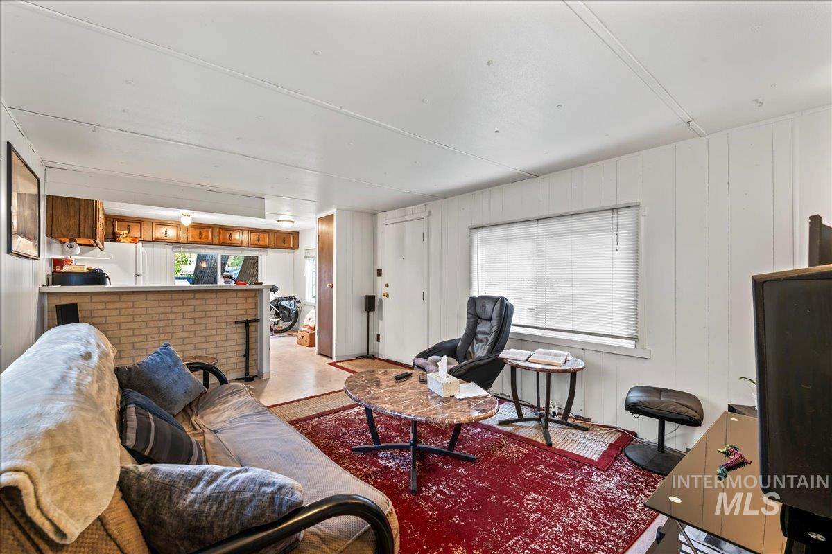 Living area featuring plenty of natural light and wooden walls
