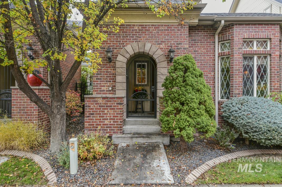 View of exterior entry featuring brick siding