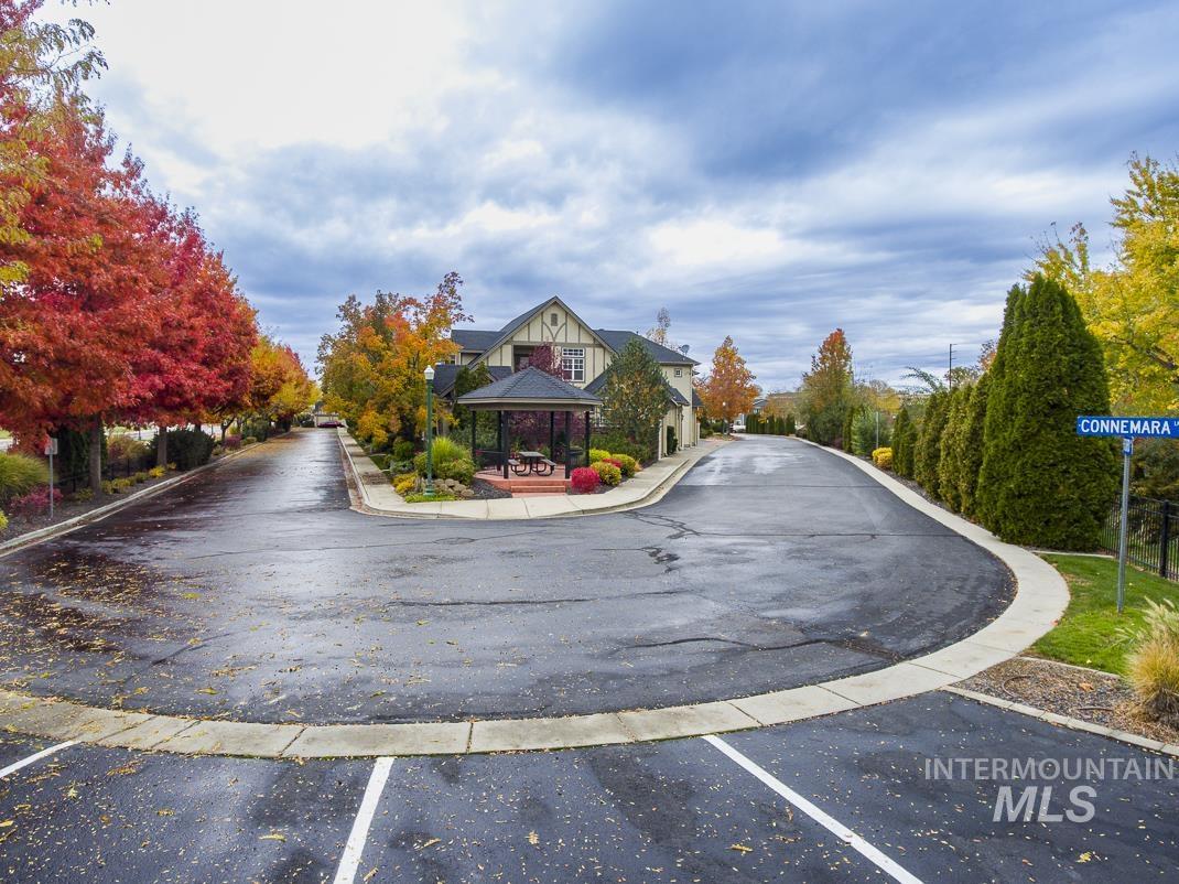 View of asphalt road featuring curbs and sidewalks