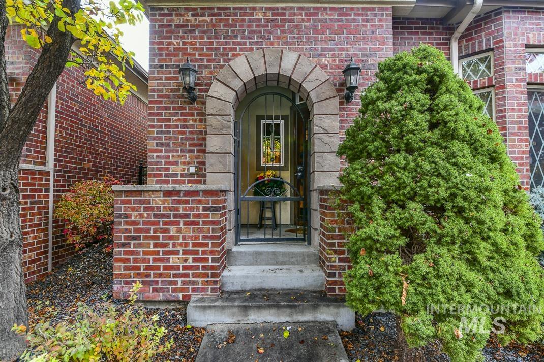 Doorway to property featuring brick siding