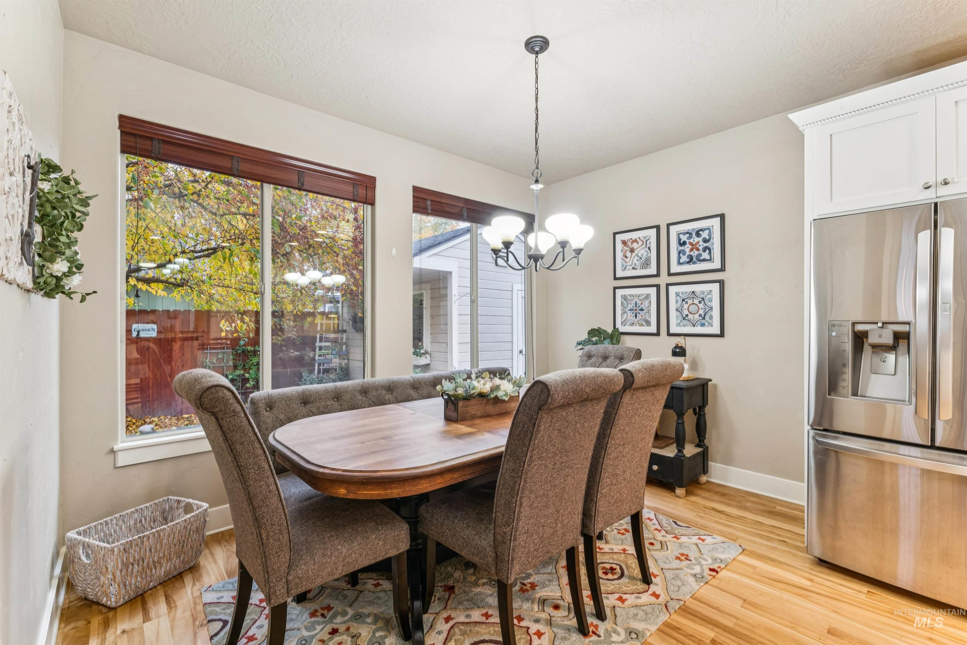 Dining area with a chandelier and light wood-style flooring
