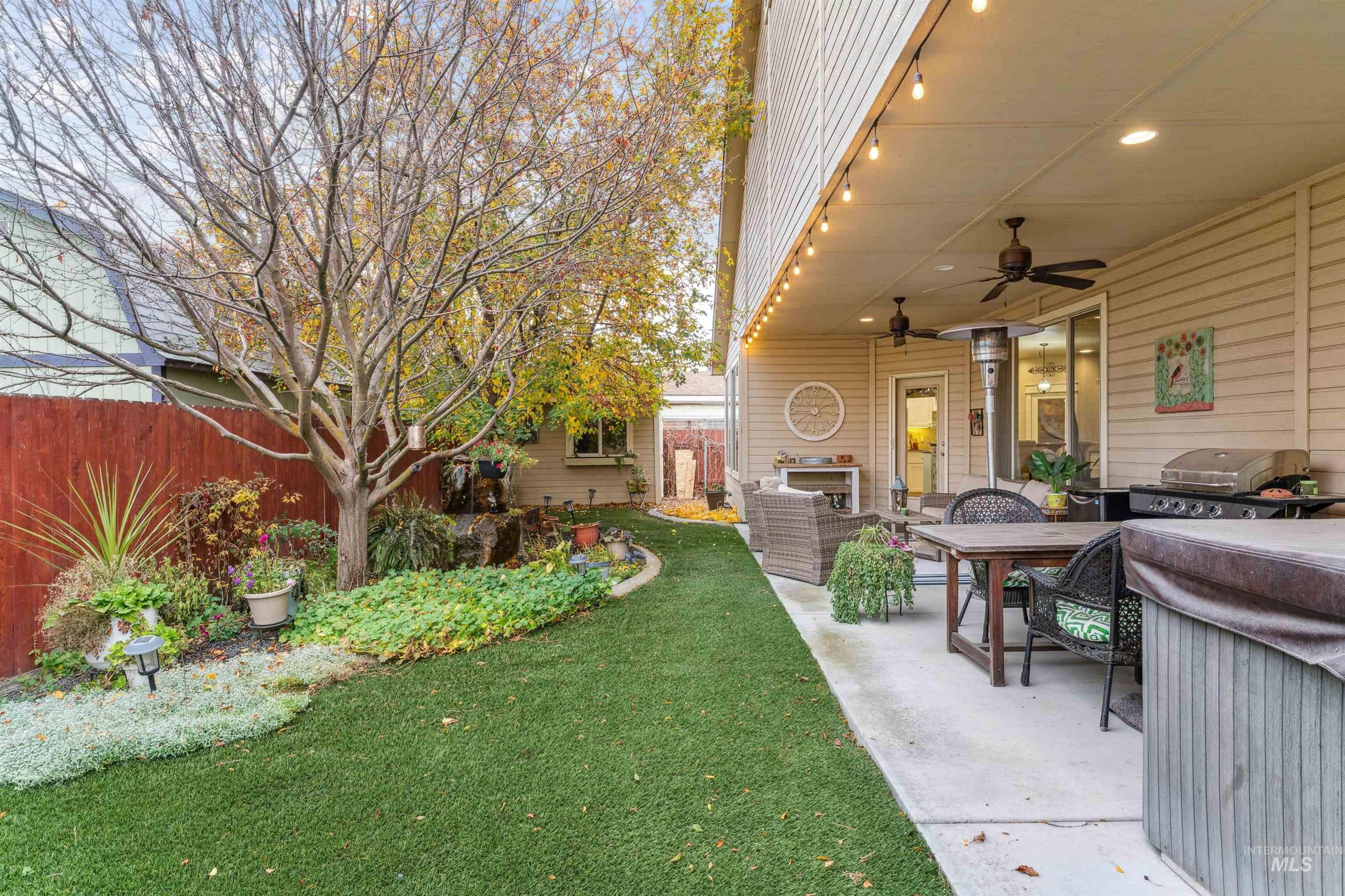 View of yard featuring a ceiling fan and a patio area