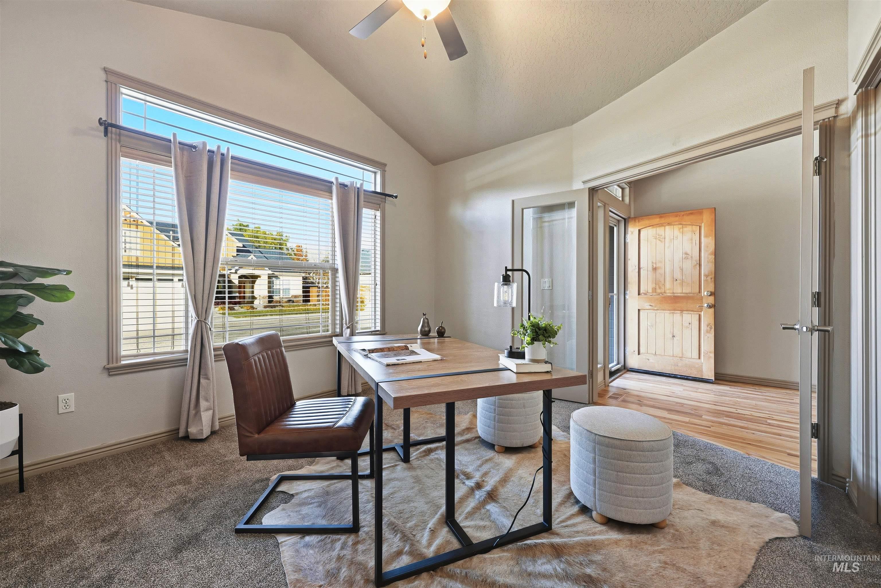 Office with light carpet, vaulted ceiling, and a ceiling fan