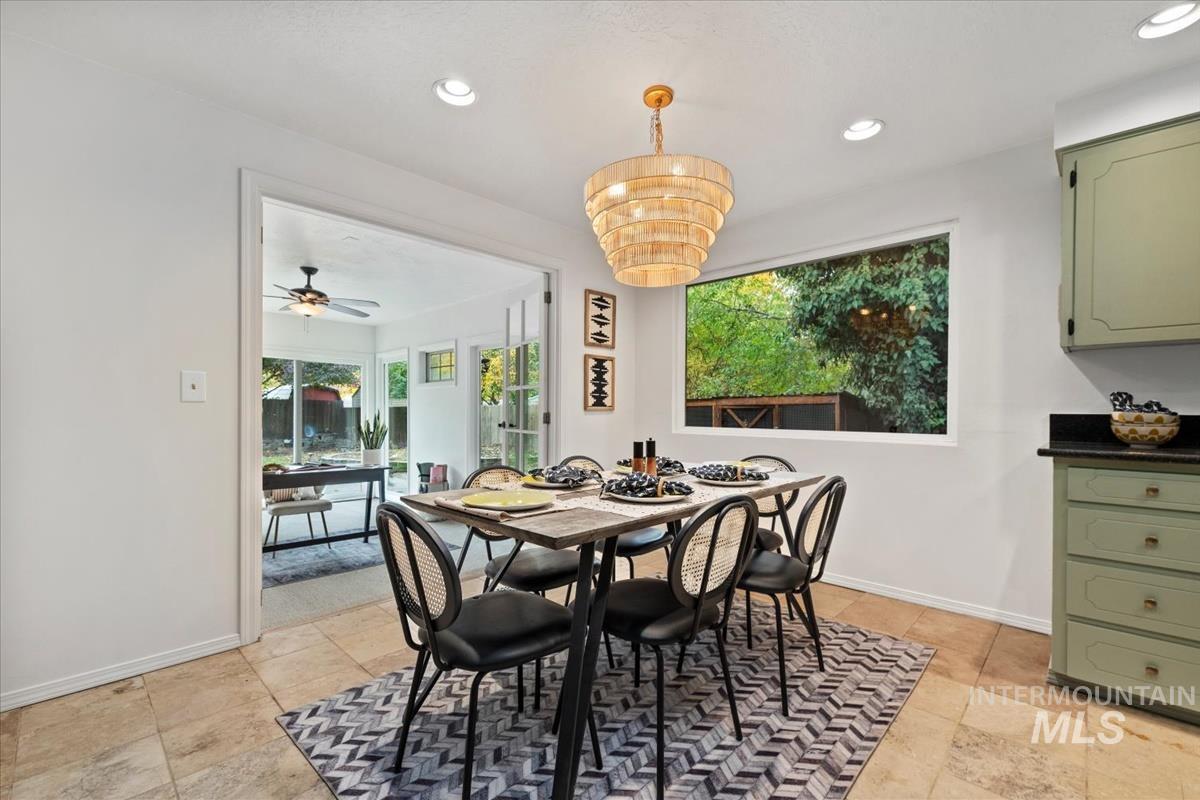 Dining area featuring recessed lighting, a chandelier, and a ceiling fan