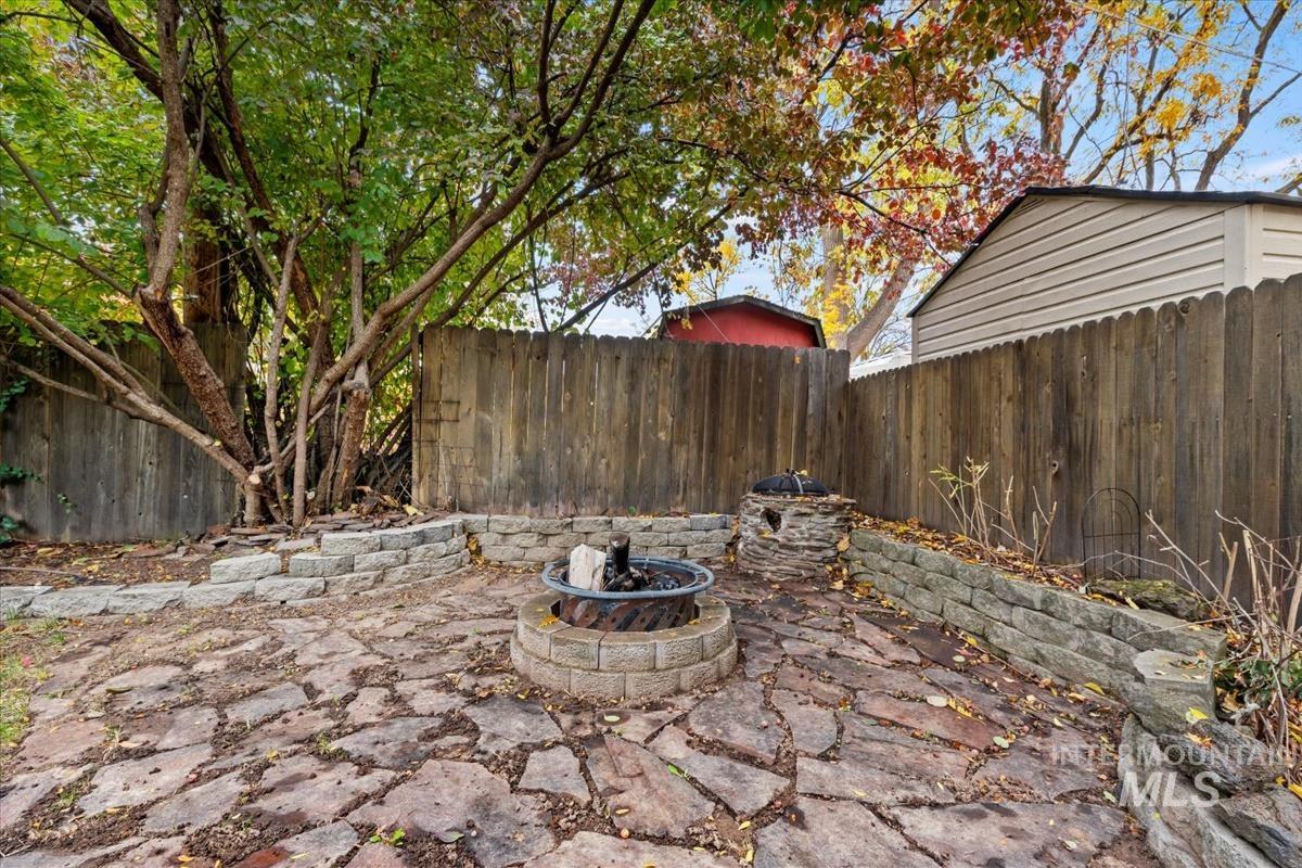 Fenced backyard with an outdoor fire pit