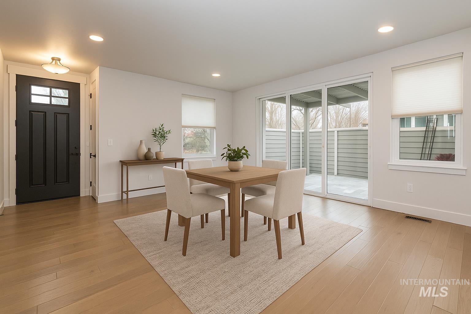Dining area with healthy amount of natural light, recessed lighting, and light wood finished floors