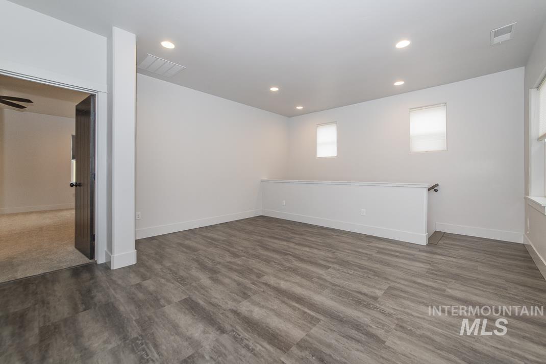 Basement with recessed lighting and light wood-style flooring