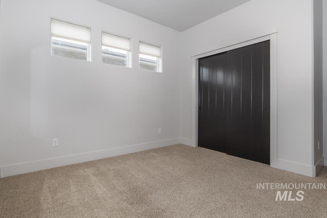 Unfurnished bedroom featuring carpet and a closet