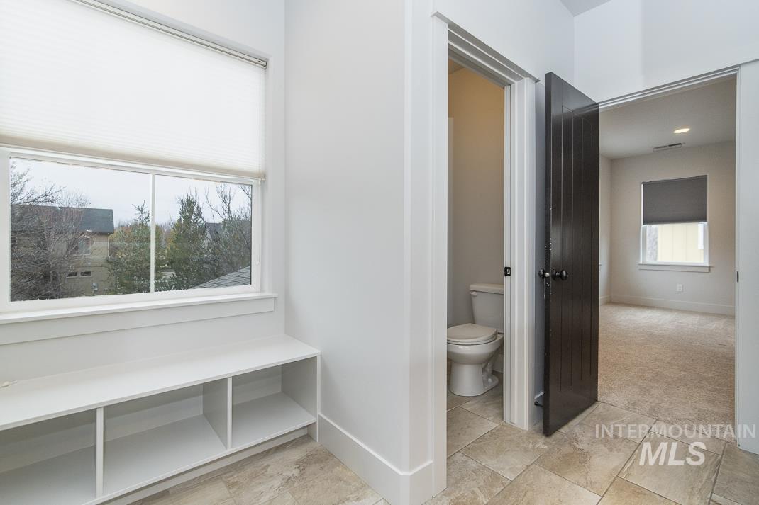 Bathroom featuring toilet and light colored carpet