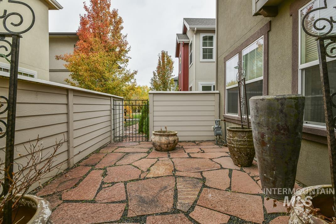 View of patio featuring a gate
