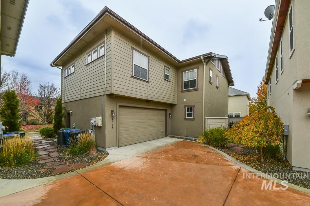 View of home's exterior featuring stucco siding, an attached garage, and concrete driveway