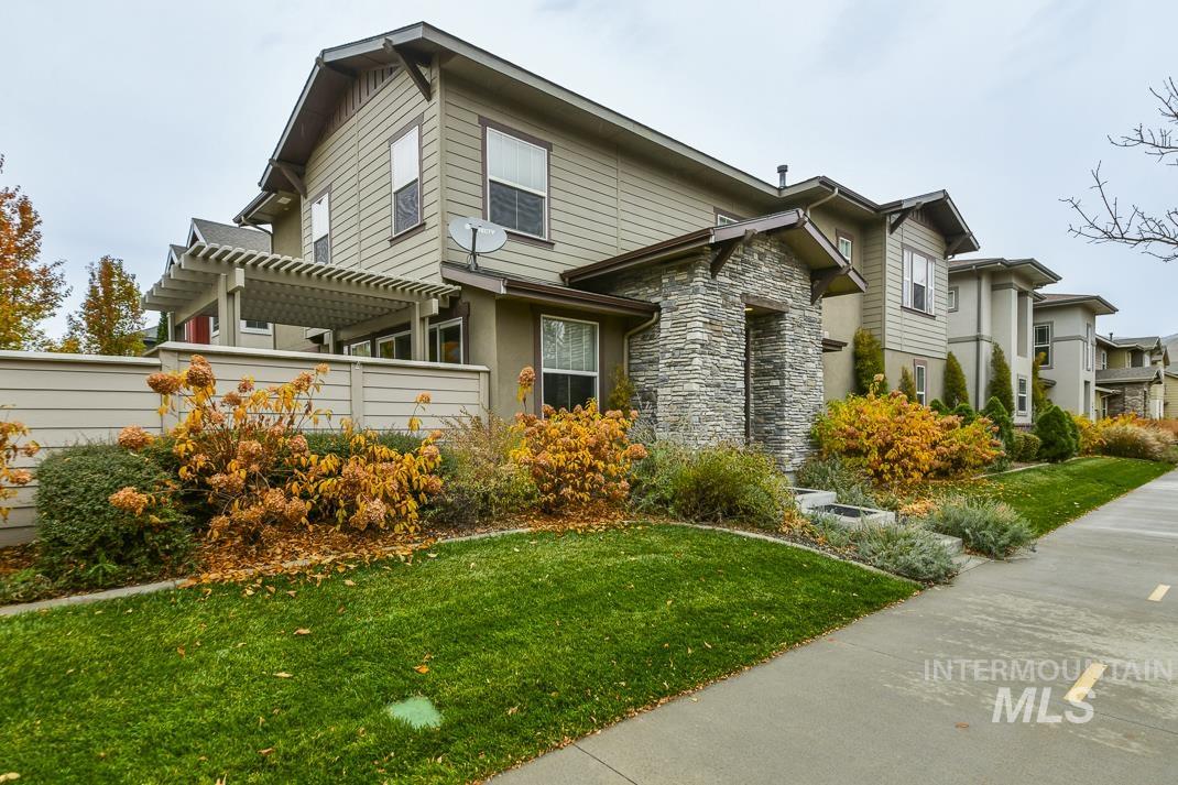 View of home's exterior featuring stone siding and a yard