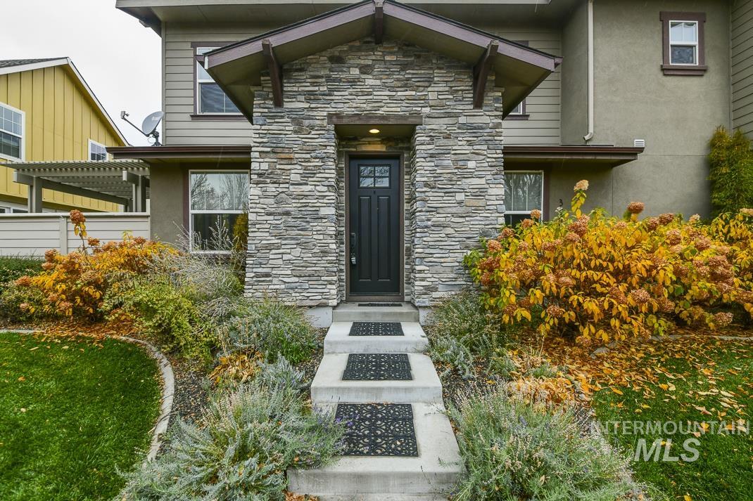 View of exterior entry featuring stone siding
