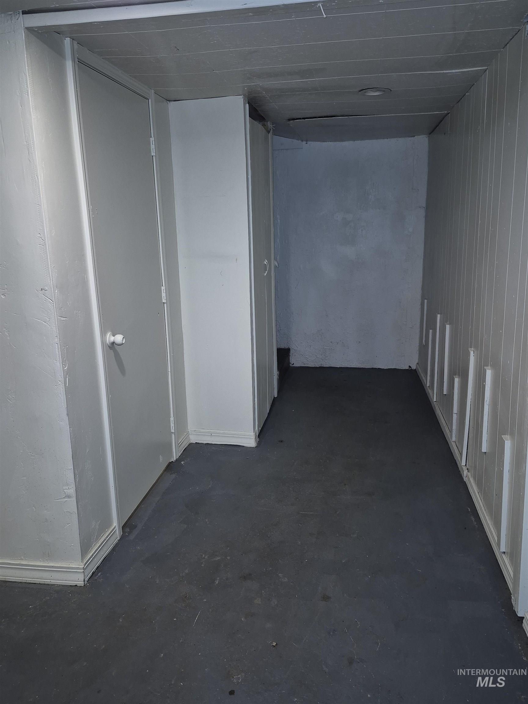 Hallway featuring concrete flooring