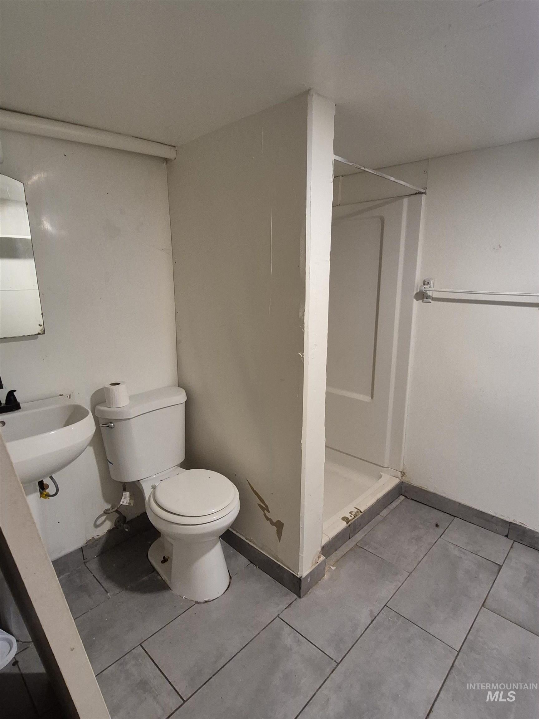 Bathroom featuring a stall shower and light tile patterned floors
