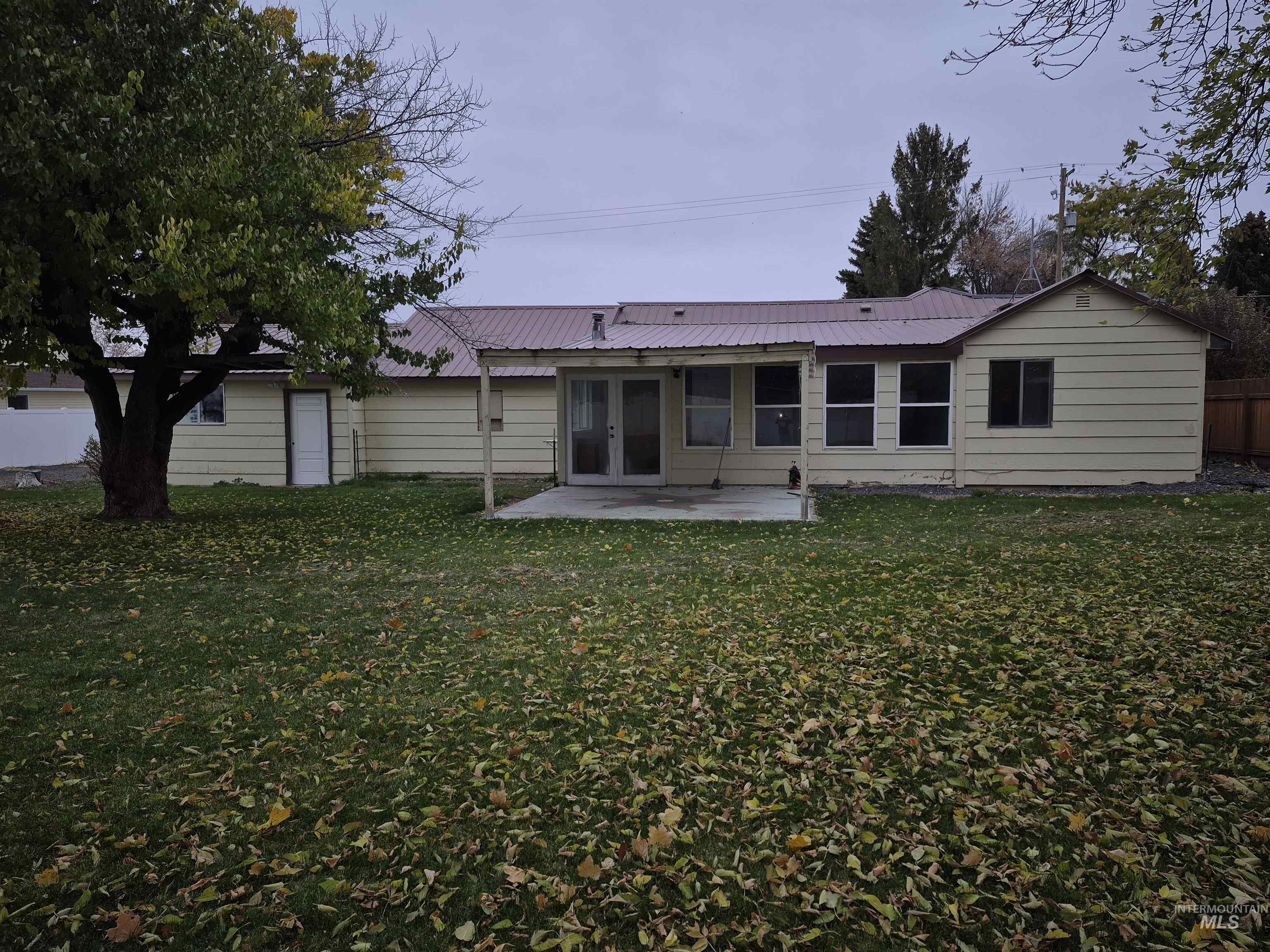 Back of property featuring a metal roof, a patio area, and french doors