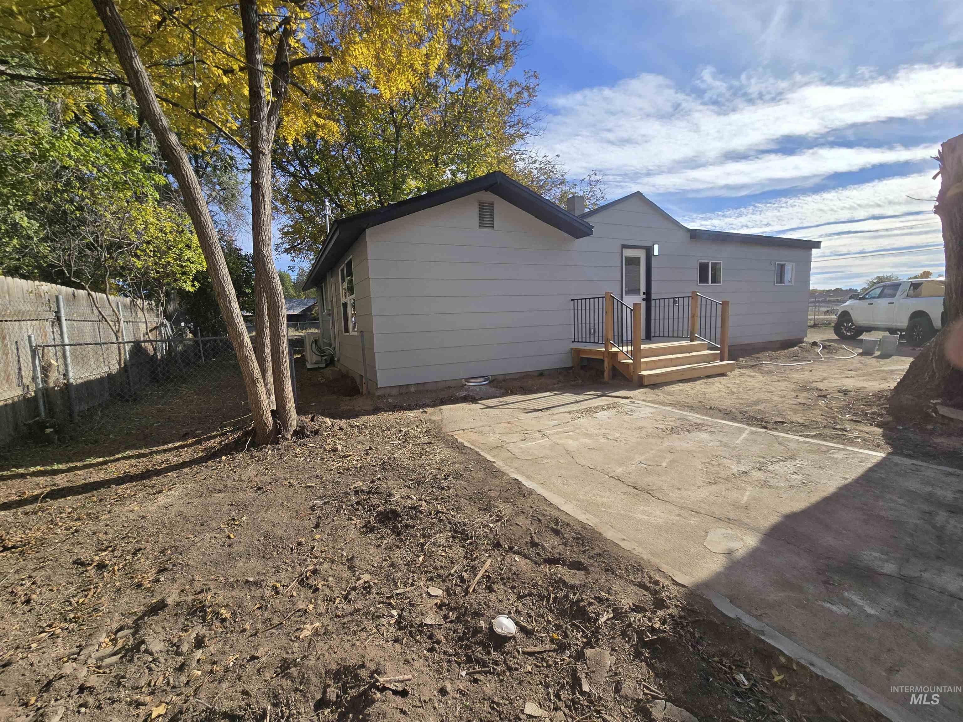 Rear view of property with a fenced backyard