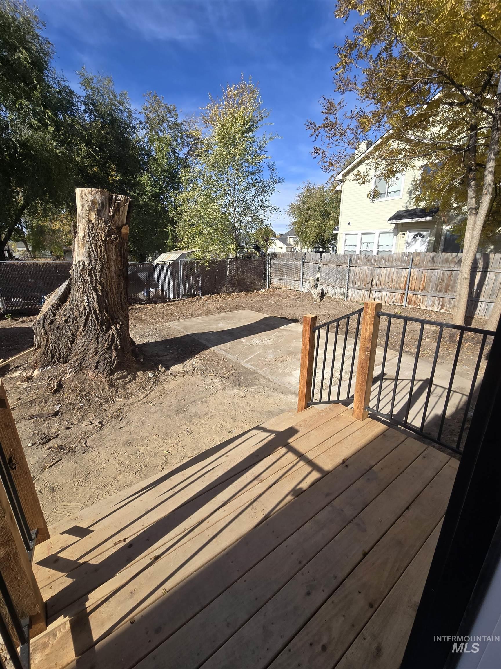 Deck featuring a fenced backyard and a shed