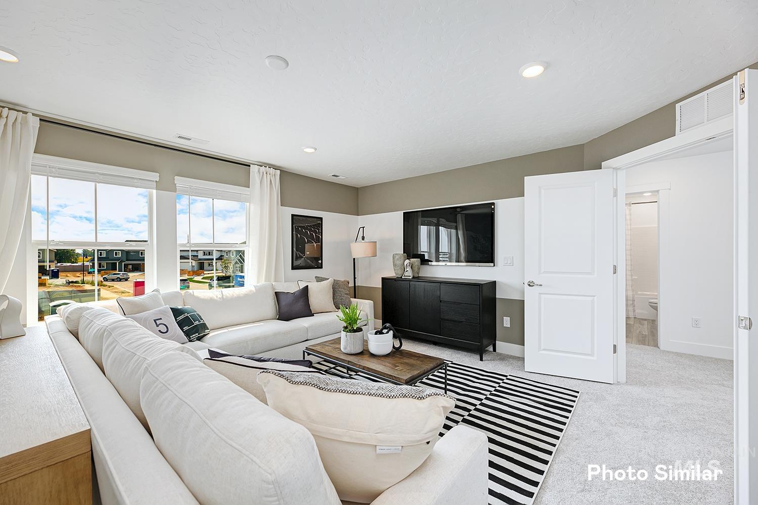 Living area with carpet floors and recessed lighting