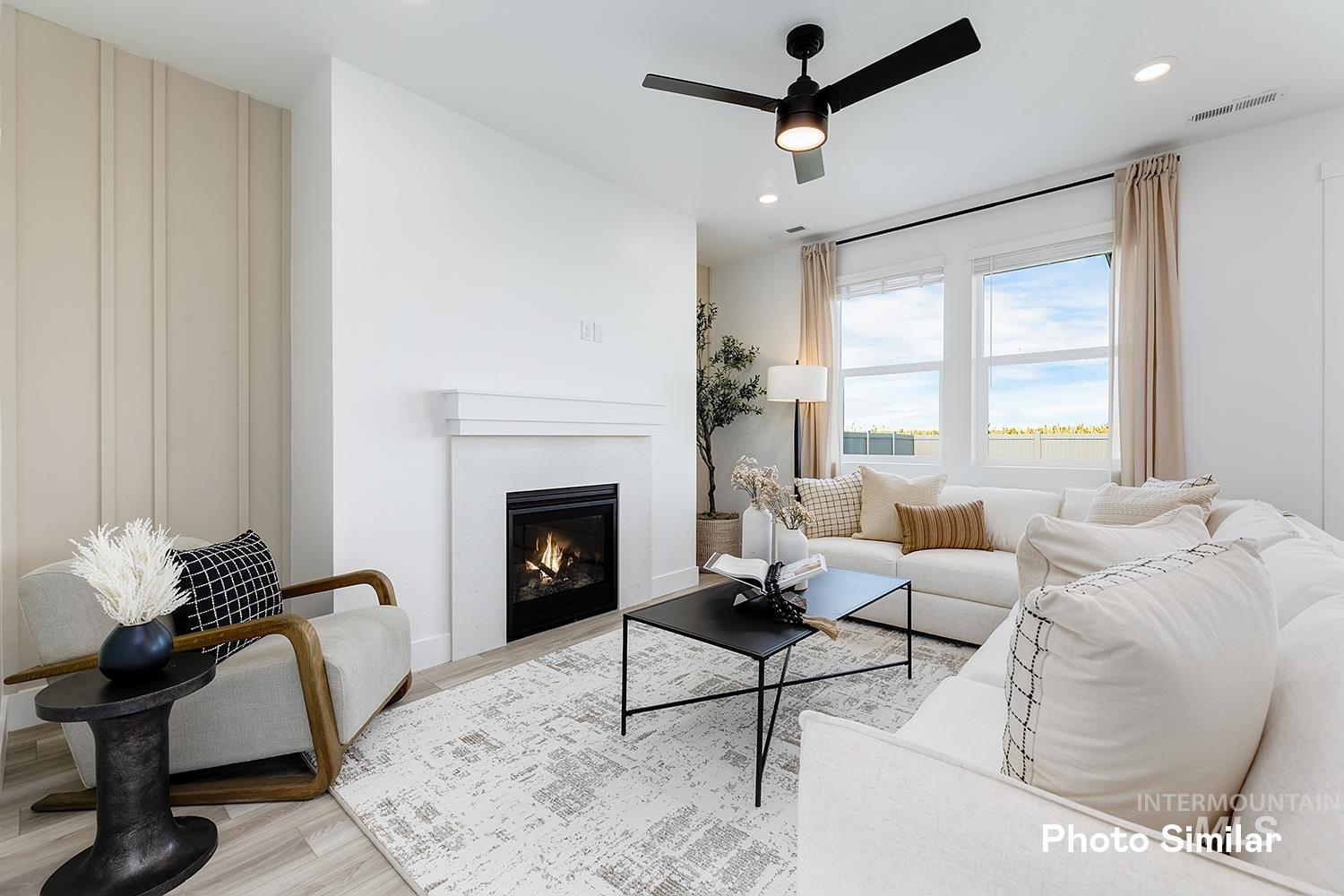 Living area featuring a glass covered fireplace, light wood-style floors, ceiling fan, and recessed lighting