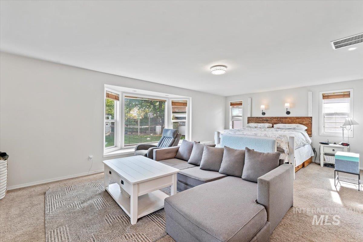 Bedroom featuring carpet floors and baseboards